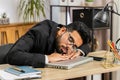 Bored sleepy business man worker working on laptop computer, falling asleep at home office Royalty Free Stock Photo