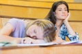 Bored student listening while classmate sleeping Royalty Free Stock Photo