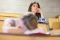 Bored student listening while classmate sleeping Royalty Free Stock Photo