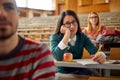 Bored student listening to teacher  in amphitheater Royalty Free Stock Photo