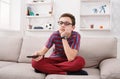 Bored teenage boy watching tv at home Royalty Free Stock Photo