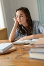 Bored teenage girl studying books at home Royalty Free Stock Photo