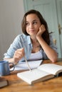 Bored teenage student girl studying at home Royalty Free Stock Photo