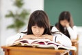 bored teenager student resting on stack of b