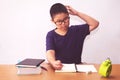 Bored and tired asian student boy doing homework Royalty Free Stock Photo