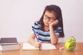 Bored and tired asian student girl doing homework Royalty Free Stock Photo