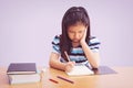 Bored and tired asian student girl doing homework Royalty Free Stock Photo
