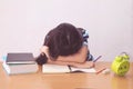 Bored and tired asian student girl doing homework Royalty Free Stock Photo