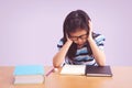 Bored and tired asian student girl doing homework Royalty Free Stock Photo