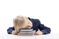 Bored and tired blond boy put head on textbooks and notebooks and sleeps. Overloaded child Royalty Free Stock Photo