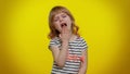 Bored tired blonde teen kid child girl yawning, sleepy inattentive feeling, lack of sleep, lazy Royalty Free Stock Photo