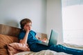 Bored and tired boy with a laptop, distant remote education during quarantine