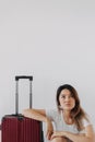 Bored and tired face woman in her private loungewear and baggage isolated on white. Royalty Free Stock Photo