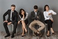 bored and tired interracial business people in formal wear waiting