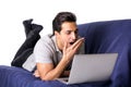 Bored or tired young man yawning while working on laptop computer Royalty Free Stock Photo