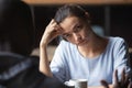 Bored unhappy girlfriend listening to African American boyfriend in cafe Royalty Free Stock Photo