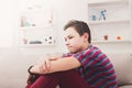 Bored unhappy teenage boy sitting at home Royalty Free Stock Photo
