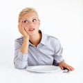 Bored, upset and woman with a plate in a studio with starving, frustrated and grumpy face. Angry, hungry and young