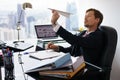 Bored White Collar Worker Throwing Paper Airplane In Office