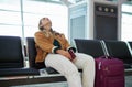 Bored woman, airport and luggage waiting with passport for missed flight, travel or vacation journey in Cape Town