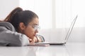 Bored woman browsing laptop in office Royalty Free Stock Photo