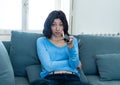 Bored woman changing TV channels with remote control