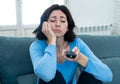 Bored woman changing TV channels with remote control