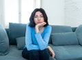 Bored woman changing TV channels with remote control