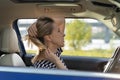 Bored woman drive car look in mirror play with hair in traffic jam. Female driver distract from road Royalty Free Stock Photo