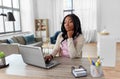 Bored woman with laptop working at home office Royalty Free Stock Photo