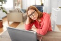 Bored woman with laptop working at home office Royalty Free Stock Photo