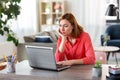 Bored woman with laptop working at home office Royalty Free Stock Photo