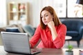 Bored woman with laptop working at home office Royalty Free Stock Photo