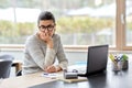 Bored woman with laptop working at home office Royalty Free Stock Photo