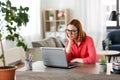 Bored woman with laptop working at home office Royalty Free Stock Photo