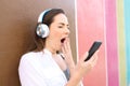 Bored woman yawning using smart phone