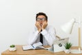 Bored at work concept, tired unmotivated male worker wasting time at workplace Royalty Free Stock Photo