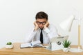 Bored at work concept, tired unmotivated male worker wasting time at workplace Royalty Free Stock Photo