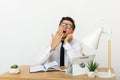 Bored at work concept, tired unmotivated male worker wasting time at workplace Royalty Free Stock Photo