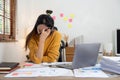 Bored workaholic accountant wmployee with Headache. stressed working woman at business desk at home. Royalty Free Stock Photo