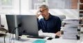 Bored Workaholic Businessman At Office Desk