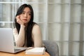 A bored Asian female college student, looking away from the camera with a boring face Royalty Free Stock Photo