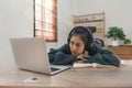 Bored young asian girl student studying, looking upset at laptop screen, attend boring online classes or lecture. Tired Royalty Free Stock Photo