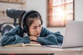 Bored young asian girl student studying, looking upset at laptop screen, attend boring online classes or lecture. Tired Royalty Free Stock Photo