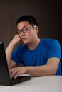 Bored young asian man working with his computer Royalty Free Stock Photo