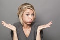 Bored young blond woman blowing her cheeks out Royalty Free Stock Photo