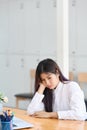 Bored woman office worker sitting at her workplace. Royalty Free Stock Photo