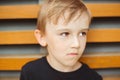 Boredom child. Face expression. Sad young boy. Unhappy lonely boy thinking about something Royalty Free Stock Photo