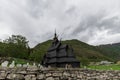 Norwegian Stave Church With Cemetary And Stone Wall Foreground In Borgund Norway