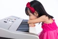 Boring Asian Chinese little girl playing electric piano keyboard Royalty Free Stock Photo